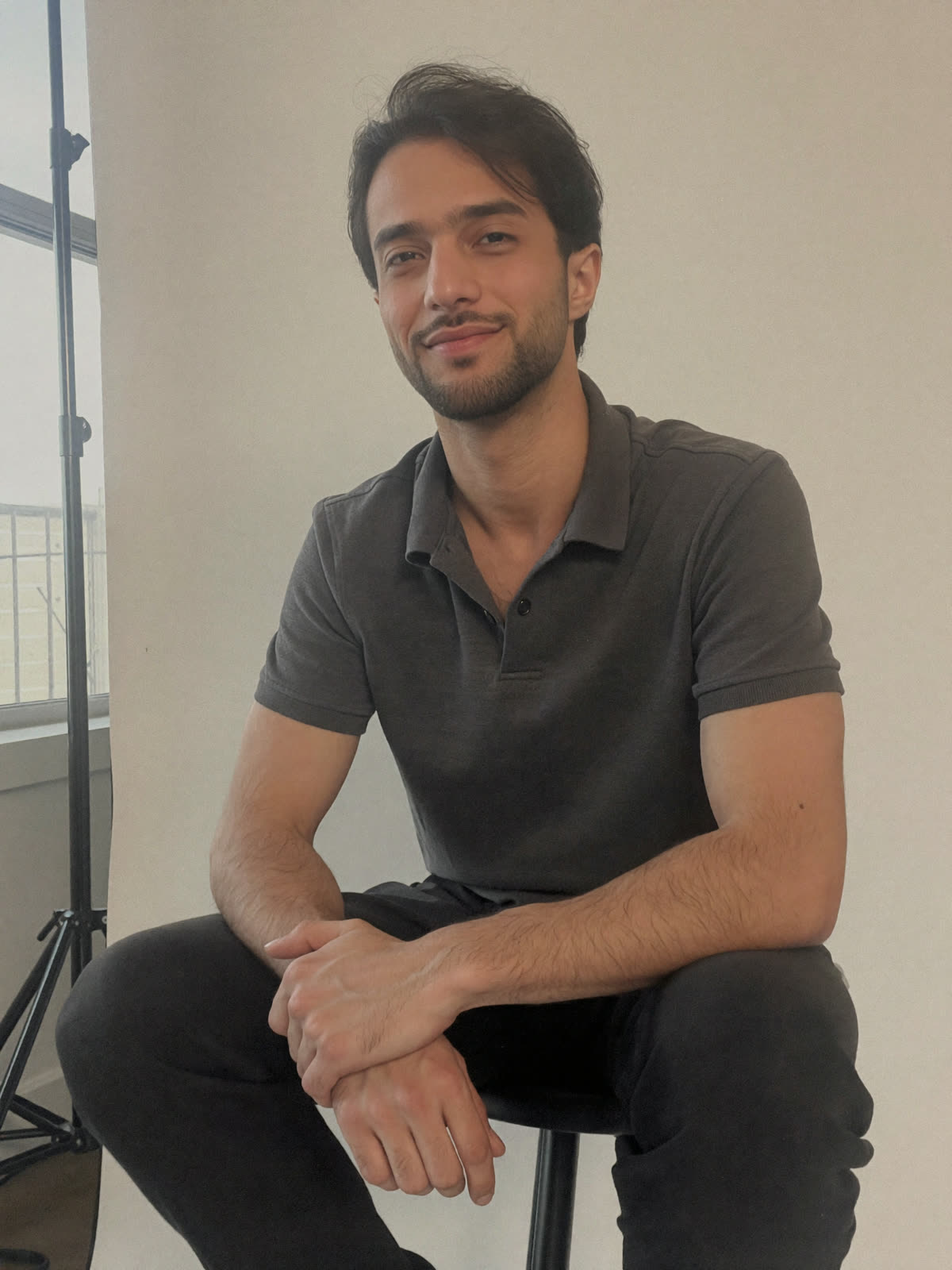 Ali Al-Khafaji standing at the studio worktable